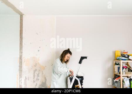 Woman renovating room Stock Photo