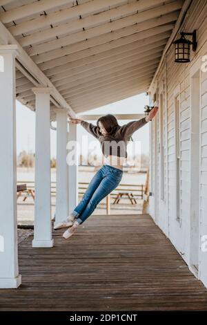 Young female teen dancer jumping in pointe shoes Stock Photo