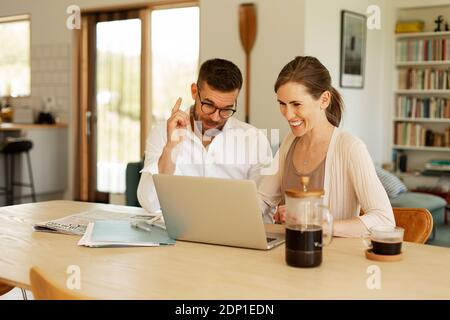 Couple working together at home Stock Photo