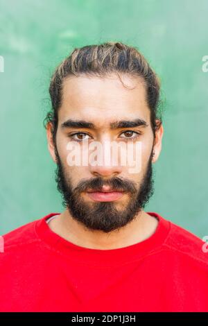 Portrait of bearded young man wearing red sweatshirt Stock Photo