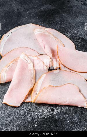 Slices of pork pastrami. Organic meat. Black background. Top view. Stock Photo