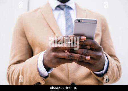 Hands of a businessman using smartphone Stock Photo