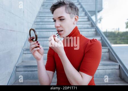 young nude binaries Nude non-binary person with red dress on tree trunk in forest Stock Photo -  Alamy