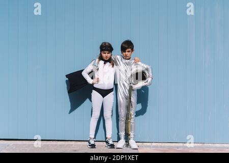 Two kids in astronaut and superhero costumes Stock Photo