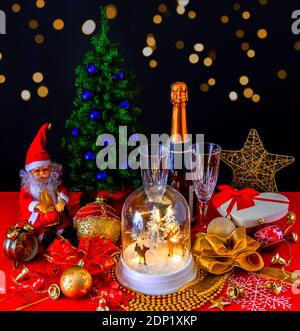Happy New Year composition with Christmas tree, Santa Claus, Champagne, Gifts, ornaments Stock Photo