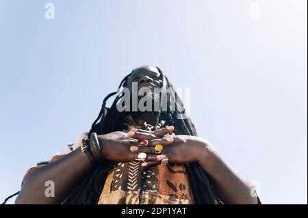 Hands with jeweled rings of man with dreadlocks Stock Photo