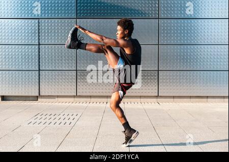 Spain, Madrid, Young athletic Afro man warming workout in urban area, Youth, Ethnicity, Healthy, Sport Stock Photo