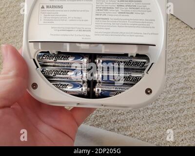 Close-up shot of the back of the Google Nest Protect smoke and carbon monoxide alarm, showing Energizer batteries in the battery compartment, in Lafayette, California, December 6, 2020. () Stock Photo
