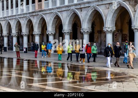 A Tour Group In St Mark’s Square During Acqua Alta (High Tide), Venice, Italy. Stock Photo