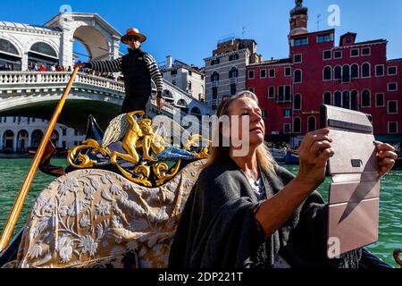 A Woman Taking A Selfie On A Gondola Ride, The Grand Canal, Venice, Italy. Stock Photo