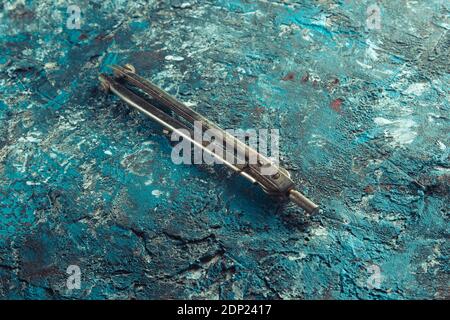Old compass drawing on a blue concrete background Stock Photo