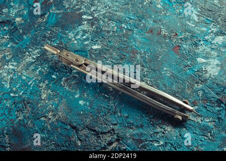 Old compass drawing on a blue concrete background Stock Photo