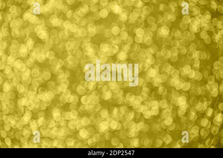 Golden abstract bokeh background. Color of the year 2021. Illuminating background. Christmas textures. Stock Photo