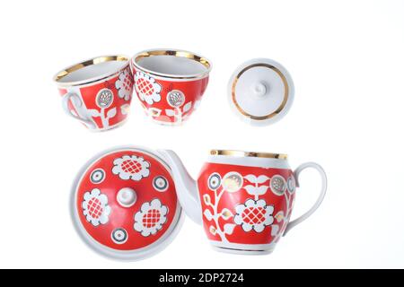 Set of retro ceramic cups with patterns, teapots, sugar bowl isolated on white background Stock Photo