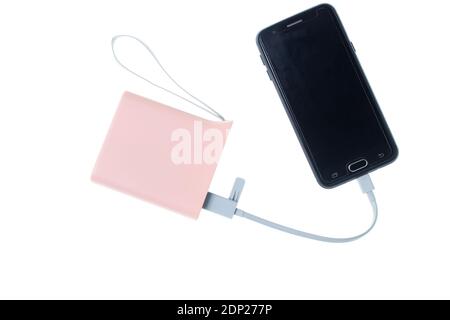 Modern smartphone charging from power bank isolated on white background. Gadgets for smartphones, external battery Stock Photo