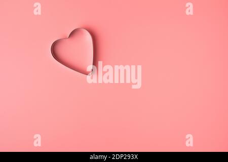 Metal heart on pink background. Top view with space to copy. Stock Photo