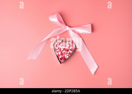 Pink bow and heart on pink background. Stock Photo