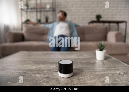 Dreamy young man enjoying music from digital wireless speaker device Stock Photo