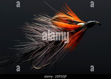 Brightly coloured hand-made fishing lure. Stock Photo