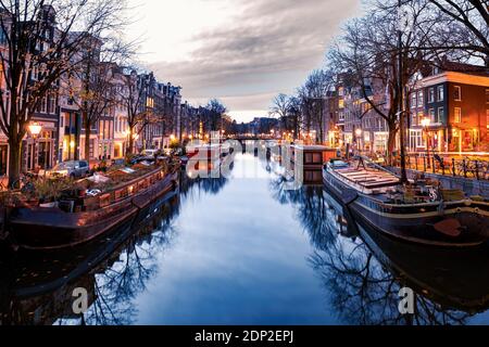 Amsterdam canals in the evening light, Dutch canals in Amsterdam Holland Netherlands during winter time in the Netherlands. Europe Stock Photo