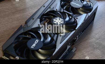 Powerful brand new NVidia GeForce RTX 3080 graphics card unboxed before installing into gaming PC. Video card cooling system fan. Computer hardware. O Stock Photo