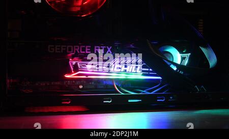 Gaming PC with NVidia GeForce RTX 3080 graphics card inside. Colorful backligts of video card and cooling fan. Powerful hardware for computer games. O Stock Photo