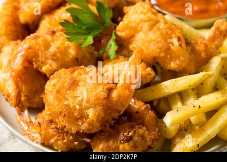 Homemade Deep Fried Coconut Shrimp with Fries and Cocktail Sauce Stock Photo