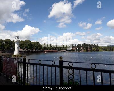 Cardiff, Wales, UK - July 2, 2020: Roath Park Lake in Cardiff. The lighthouse is the The Scott Memorial in memory of Captain Scott who left from Cardi Stock Photo