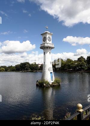 Cardiff, Wales, UK - July 2, 2020: Roath Park Lake in Cardiff. The lighthouse is the The Scott Memorial in memory of Captain Scott who left from Cardi Stock Photo