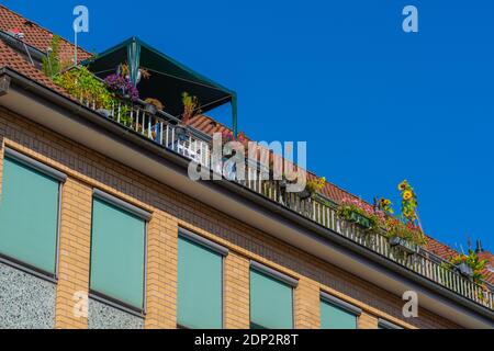 Balcony in a top flat decorated with blooming flower and pots, Hanseatic City of Lübeck, Schleswig-Holstein, North Germany, Europe Stock Photo