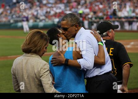 US President Barack Obama greets Congresswoman Donna Edwards D-MD while Minority Leader Nancy Pelosi (L) looks during the 2015 Congressional Baseball Game at the National Parks Stadium, in Washington, DC, USA, on June 11, 2015. Photo by Aude Guerrucci/Pool/ABACAPRESS.COM Stock Photo