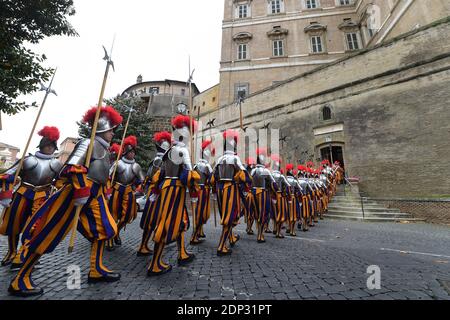 The Vatican's Swiss Guards swore in 32 new recruits on May 6, 2015 at the Vatican. The new recruits joined their ranks in an elaborate swearing-in ceremony . The ceremony is held each May 6 to commemorate the 147 Swiss Guards who died protecting Pope Clement VII during the 1527 Sack of Rome. Then each new recruit grasped the corps' flag and, raising three fingers in a symbol of the Holy Trinity, swore to uphold the Swiss Guard oath to protect pope Francis and his successors. The Swiss Guard, founded in 1506, consists of 100 volunteers who must be Swiss nationals, Catholic, single, at least 174 Stock Photo