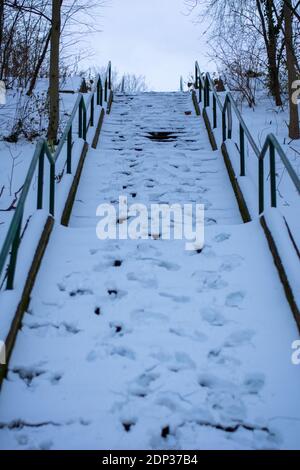 A Large Set of Stairs Covered in Snow With Footsteps In It Stock Photo