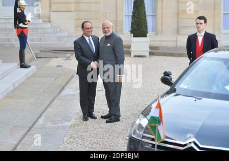 French President Francois Hollande (R) receives Indian Prime Minister Narendra Modi at the Elysee Palace in Paris, France on April 10, 2015. Modi is on a two-day state visit to France during which he will tour the Airbus facilities in Toulouse on 11 April 2015. The French government is expecting to finalise the sale of 63 Rafale fighter jets made by Dassault aviation during the state visit, a sale which would net seven billion euros. (photo by Christian liewig Stock Photo