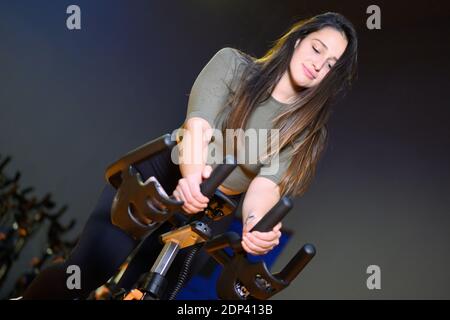 Woman in gym spinning on fitness bike. High quality photo Stock Photo