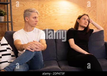 Young upset couple is sitting with a psychologist. Young couple is upset Stock Photo