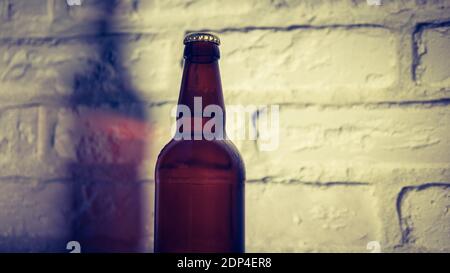 No label beer bottle. On brick wall background. Stock Photo
