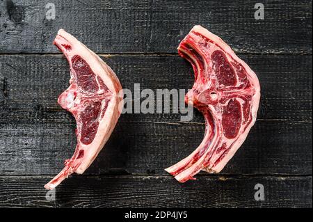 raw lamb chops fresh cut . Black background. Top view. Stock Photo