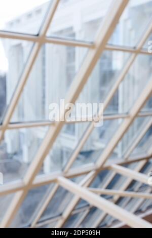 Modern architecture concept. New modern building seen through big sloping window blurred texture background vertical Stock Photo