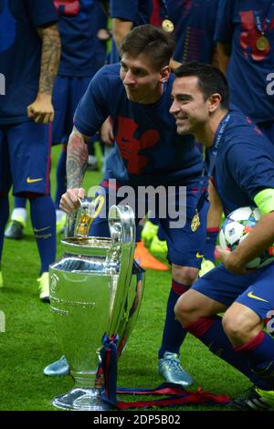 Barcelona's Lionel Messi and Xavi celebrate after receiving the