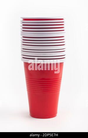 Stacked Red plastic cups isolated over white background Stock Photo
