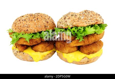 Breadcrumb covered chicken fillet sandwiches in multigrain seed covered bread rolls isolated on a white background Stock Photo