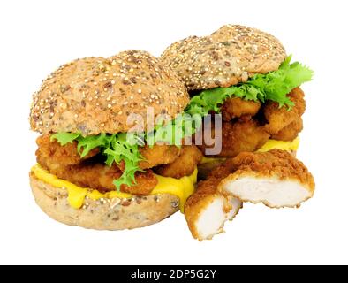 Breadcrumb covered chicken fillet sandwiches in multigrain seed covered bread rolls isolated on a white background Stock Photo