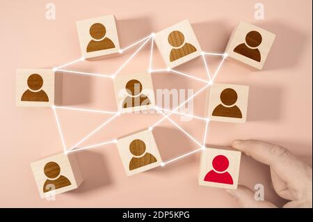 Building a strong team, Wooden blocks with people icon on blue ...