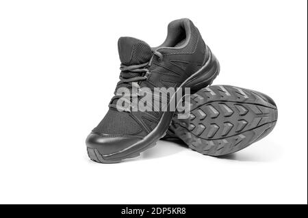 black sneakers isolated on white background. Black sneakers running shoes. Casual shoes. Youth style. Shoes for trekking, running, hikking. New black Stock Photo