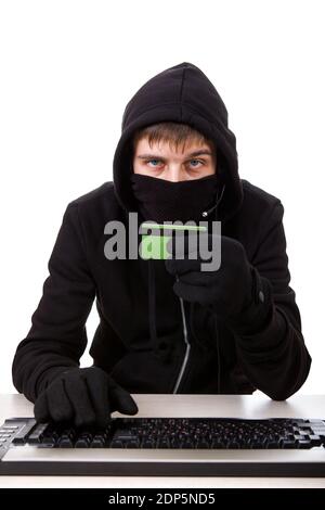 Hacker with a Bank Card and the Computer Keyboard on the White Background Stock Photo
