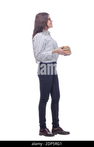 Side view of smiling woman with stacked books in hands isolated on white background Stock Photo