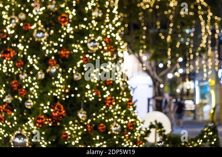 Blurred image Christmas tree and Christmas decorations  beautiful outdoor at street in park Stock Photo