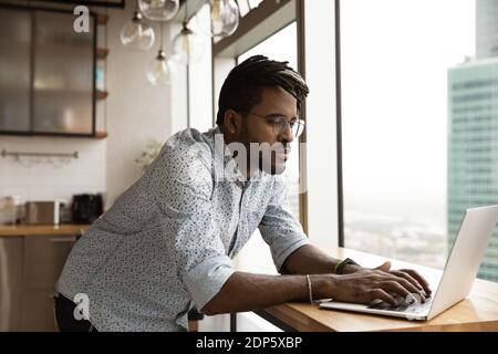 Young biracial man work online on laptop at home Stock Photo