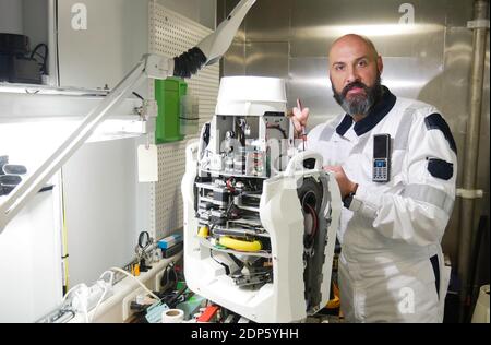 Electronics Engineer Works with on Robot. Computer Science Research Laboratory with Specialists Working. Stock Photo